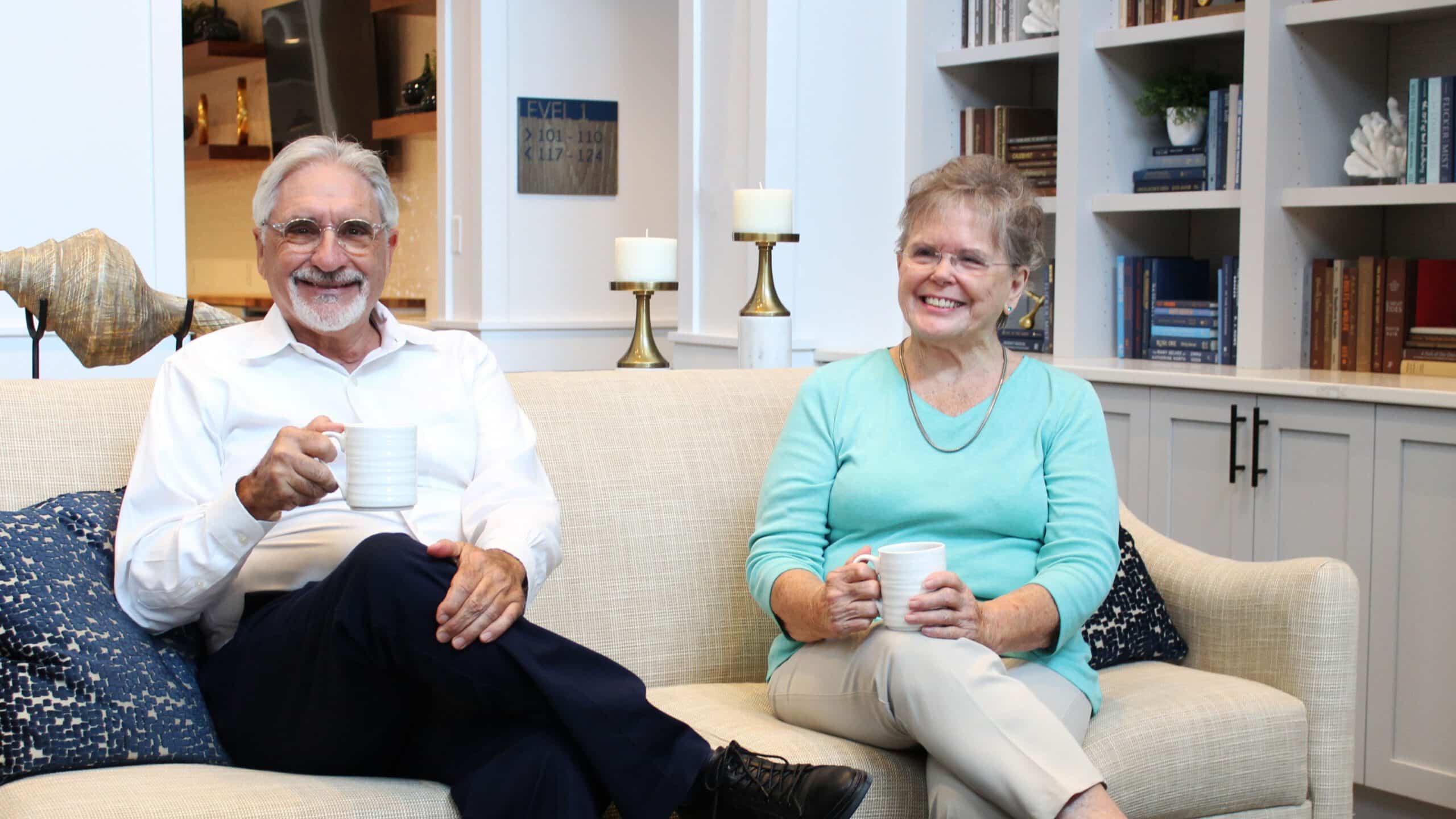Two residents smiling with coffee in the Novel Place lounge