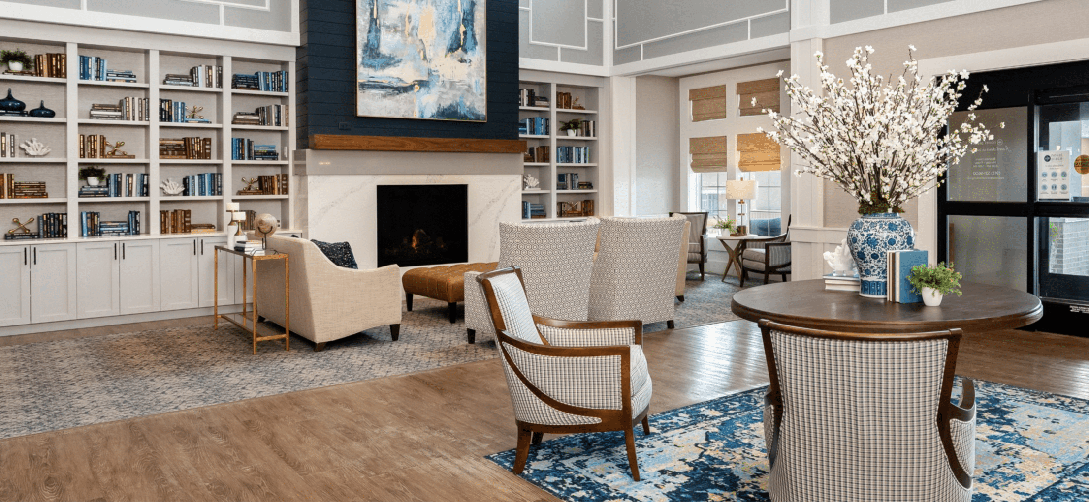 Novel Place lounge with fireplace and bookshelves